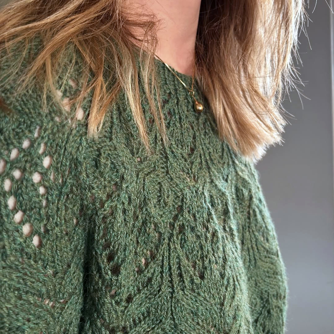 A sweater knitted in lace pattern