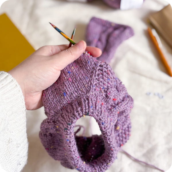 A cable sweater being knit